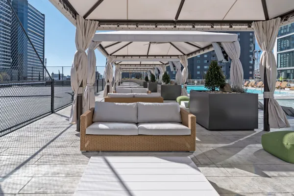 a living room with patio furniture and a floor to ceiling window