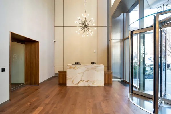 a living room with furniture and large window with wooden floor