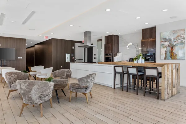 a dining room with furniture a chandelier and wooden floor