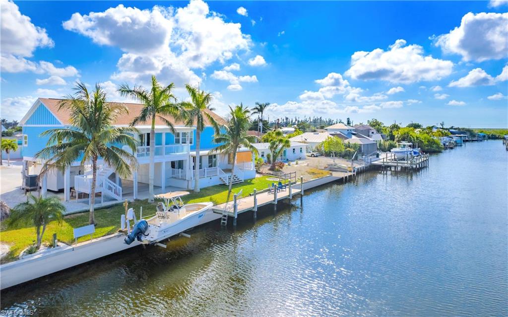 12277 Boat Shell Drive Matlacha Isles, FL 33991 - Photo 23 of 46 a view of an ocean with boats and palm trees