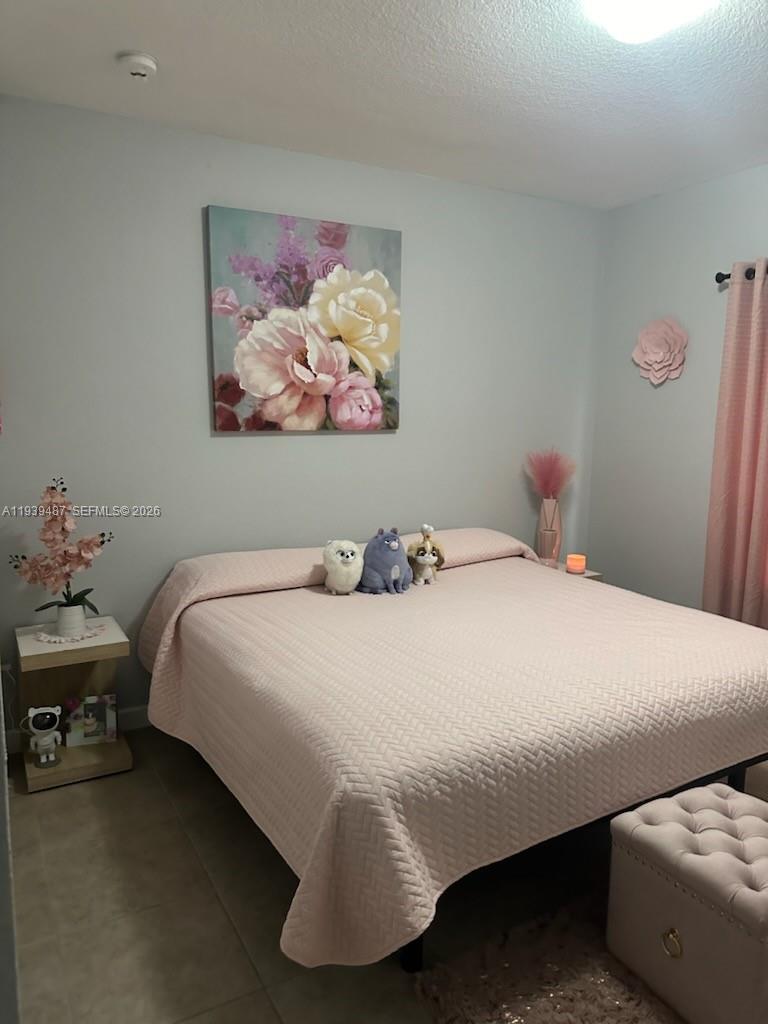 11382 Southwest 242nd Street Homestead, FL 33032 - Photo 12 of 21 a bedroom with a bed and wall painting