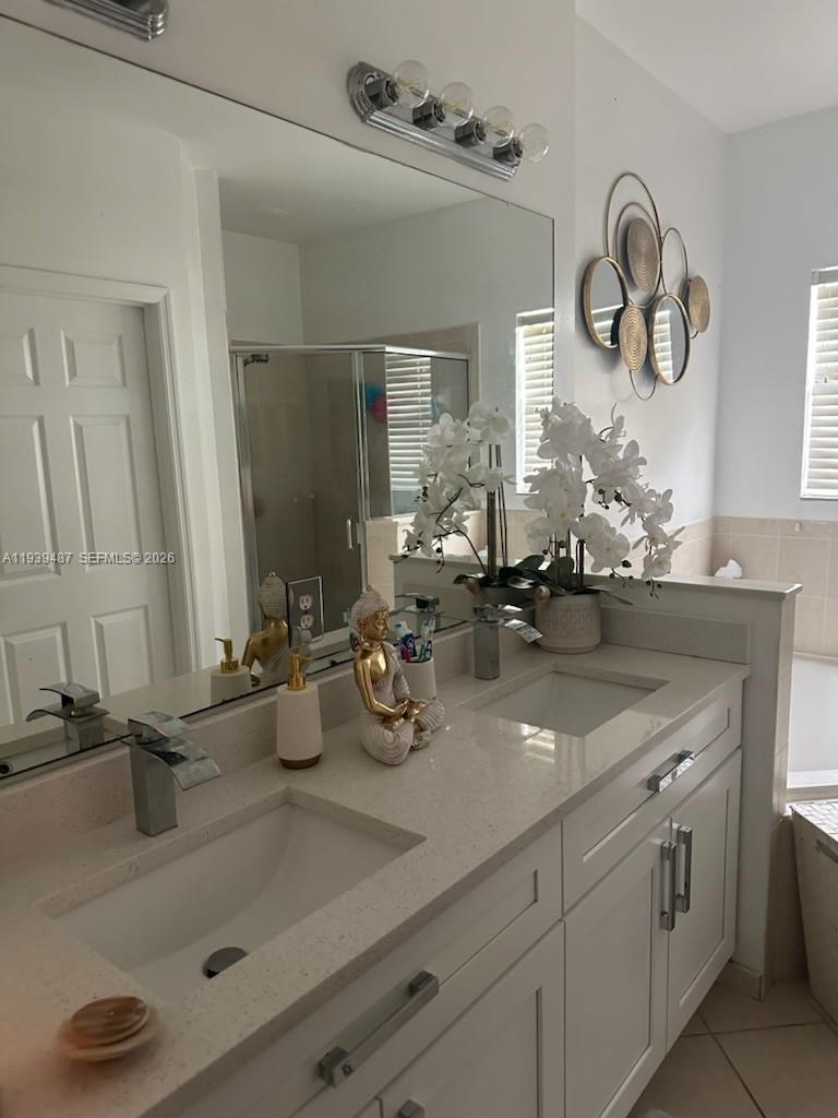 11382 Southwest 242nd Street Homestead, FL 33032 - Photo 16 of 21 a bathroom with double vanity sinks and a mirror