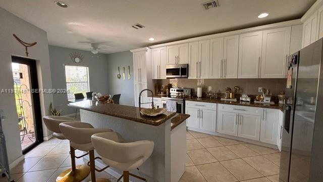 11382 Southwest 242nd Street Homestead, FL 33032 - Photo 6 of 21 a kitchen with stainless steel appliances granite countertop a sink a stove a refrigerator cabinets and a dining table