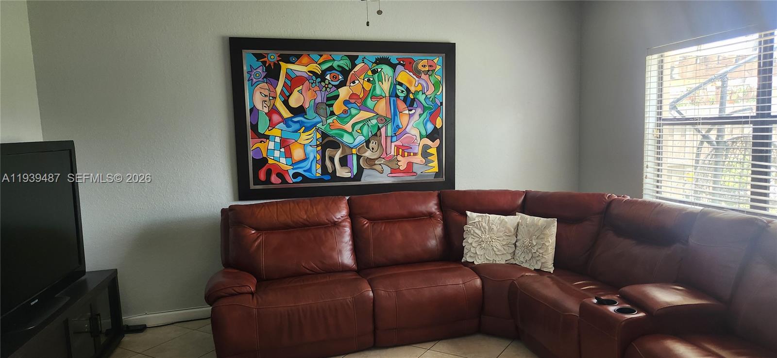 11382 Southwest 242nd Street Homestead, FL 33032 - Photo 10 of 21 a blue couch sitting next to a window
