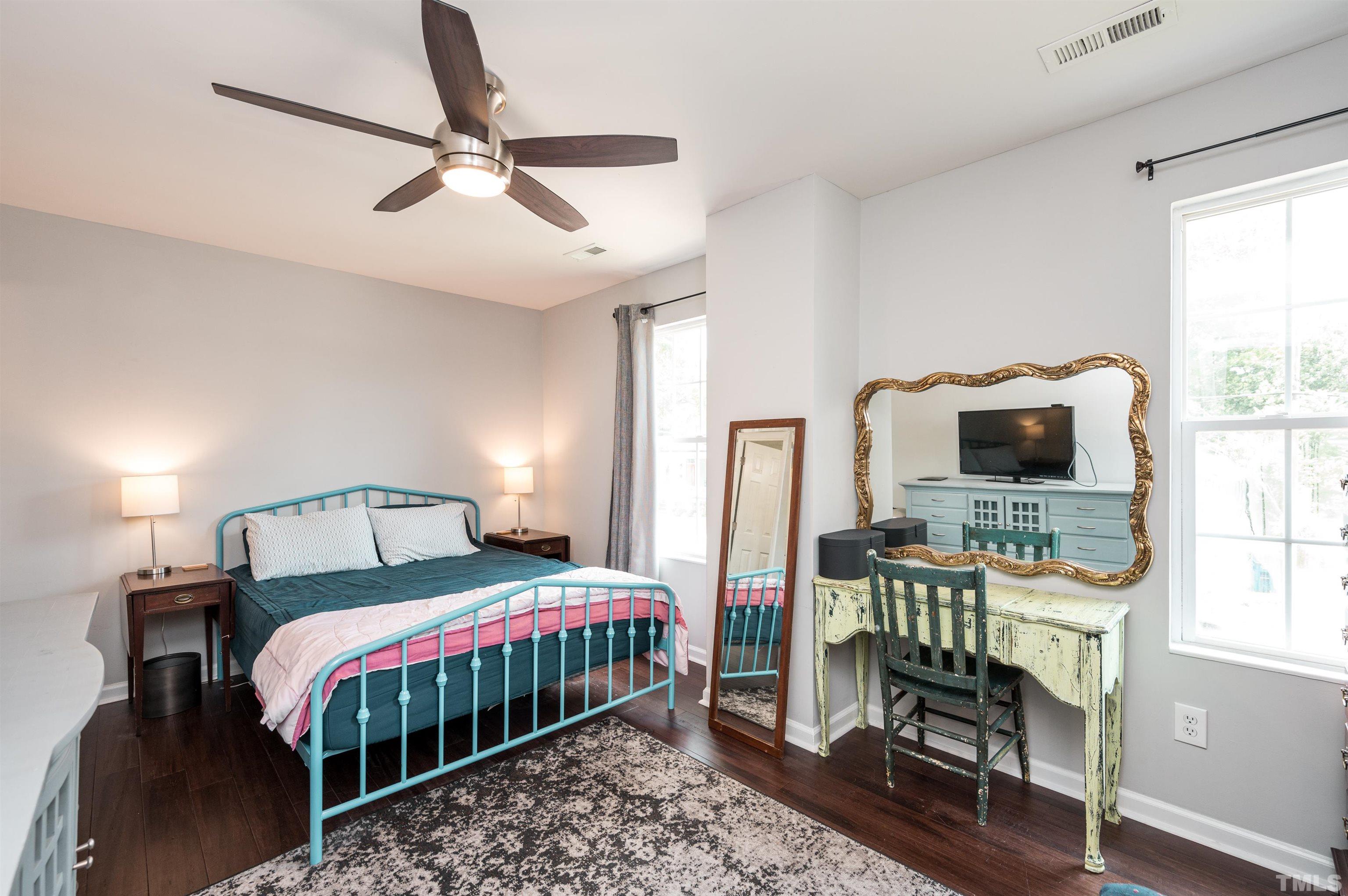 704 Quarry Street Raleigh, NC 27601 - Photo 23 of 27 a bedroom with a bed a window and a flat screen tv