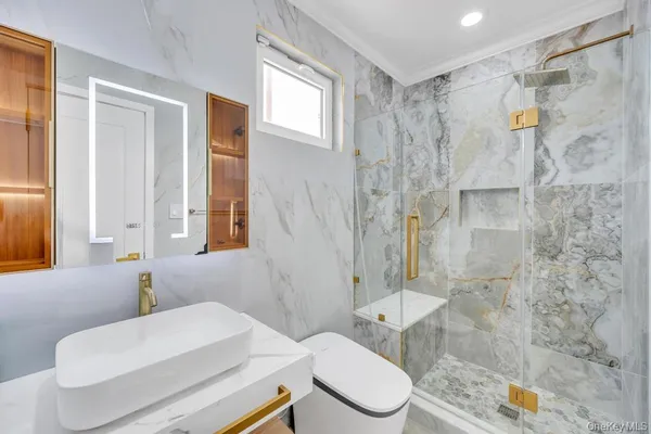 a bathroom with a sink toilet and shower