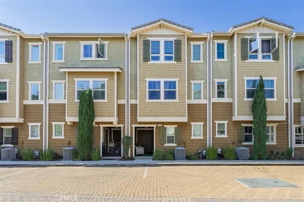 a front view of a residential apartment building with a yard