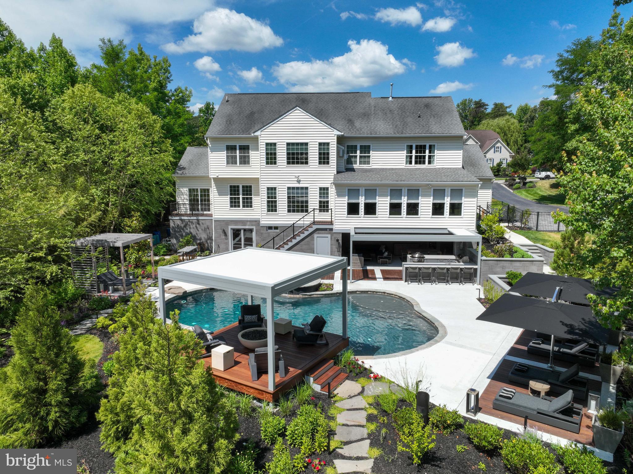 an aerial view of a house with swimming pool table and chairs
