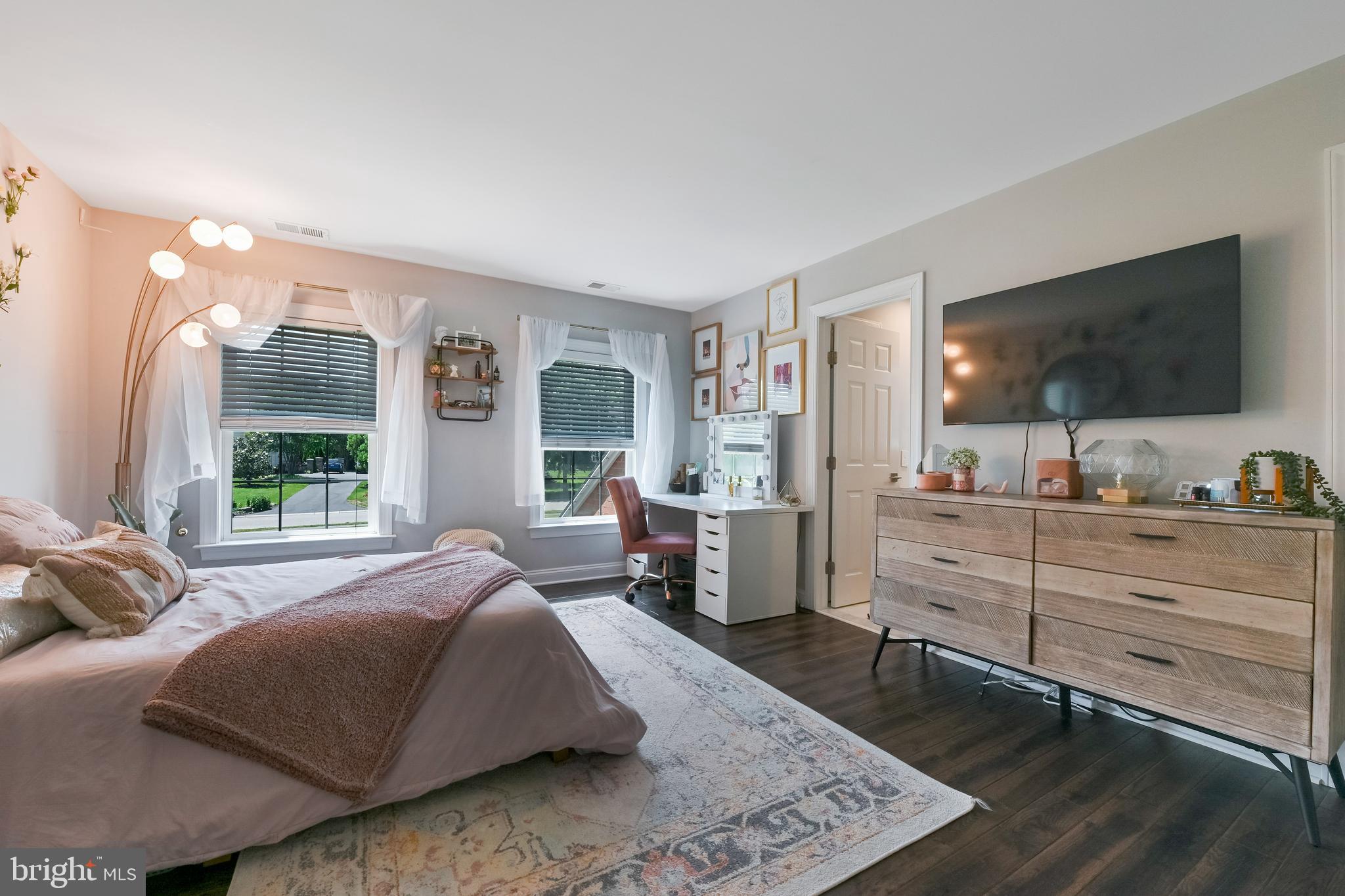 1613 Braid Hills Drive Pasadena, MD 21122 - Photo 69 of 148 a spacious bedroom with a large bed and a flat screen tv