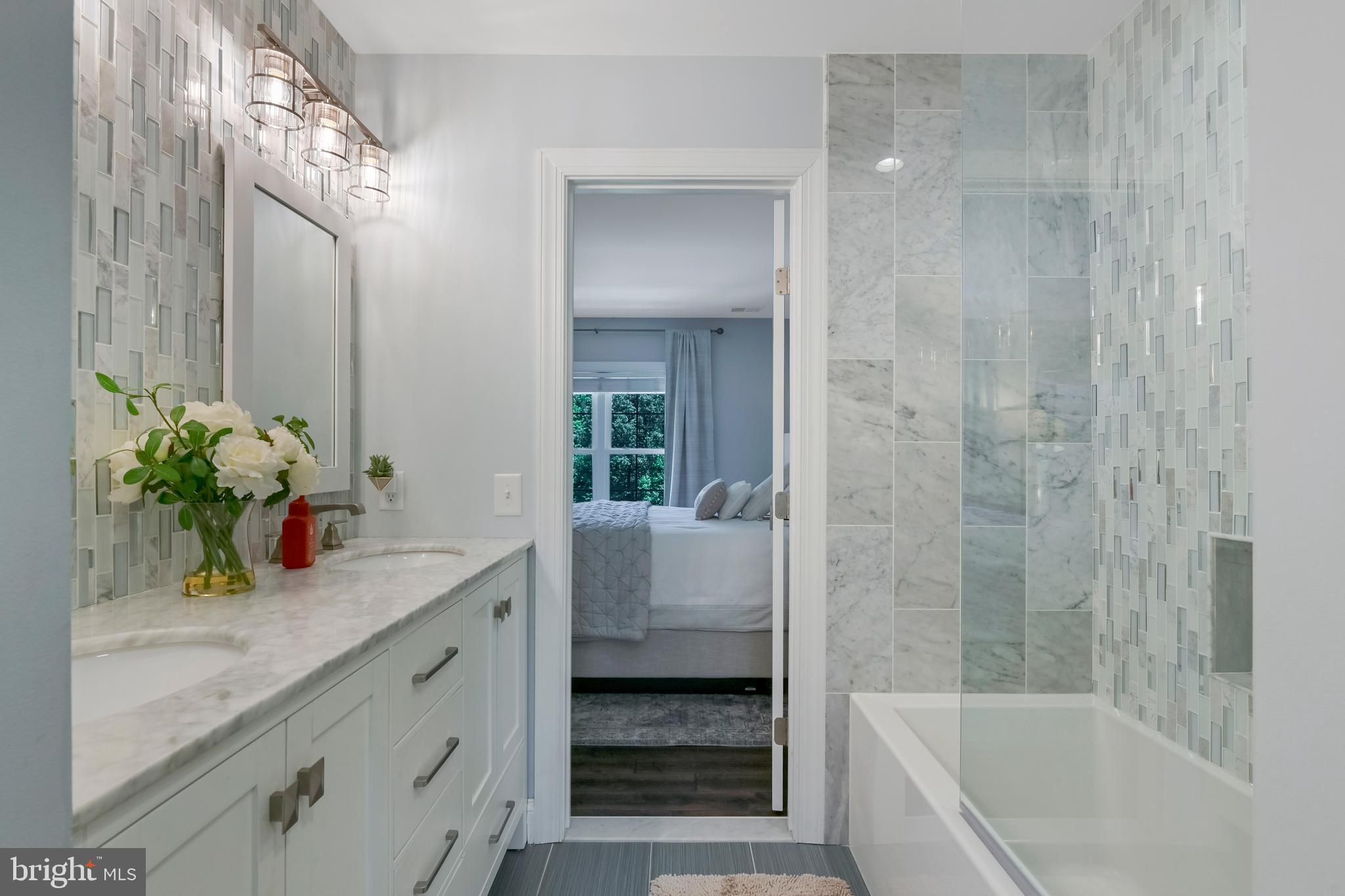 1613 Braid Hills Drive Pasadena, MD 21122 - Photo 76 of 148 a bathroom with a granite countertop sink a mirror and a bathtub