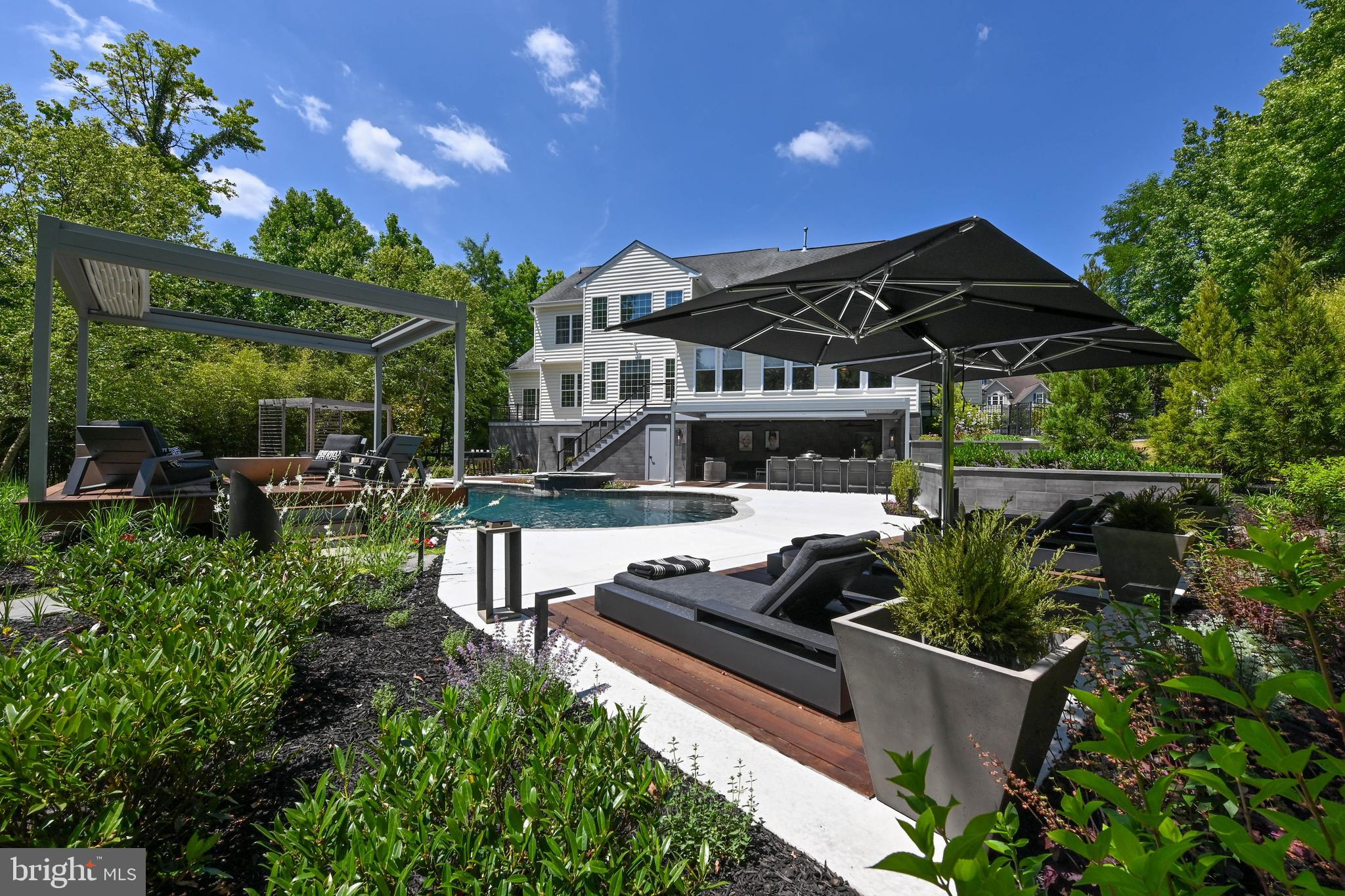 1613 Braid Hills Drive Pasadena, MD 21122 - Photo 88 of 148 a view of a chair and tables in the patio and a garden
