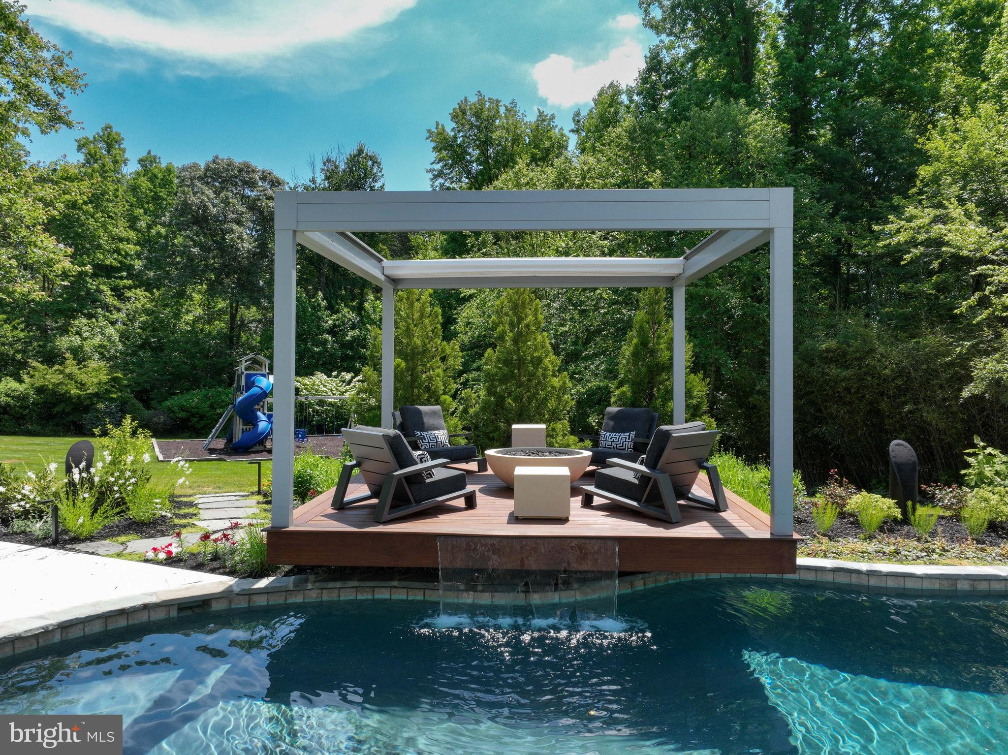 1613 Braid Hills Drive Pasadena, MD 21122 - Photo 95 of 148 a view of a patio with table and chairs potted plants with floor to ceiling window and tree