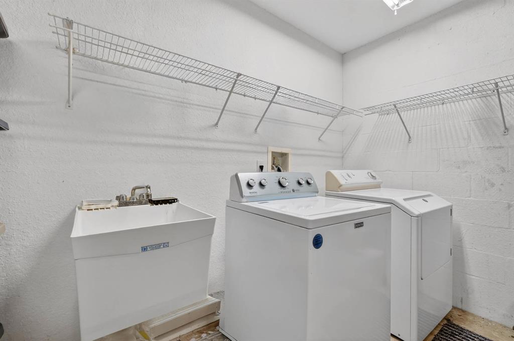 80 Roxboro Drive Palm Coast, FL 32164 - Photo 20 of 39 a utility room with cabinets washer and dryer