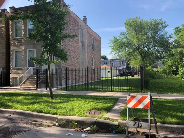 a view of backyard with swimming pool and green space