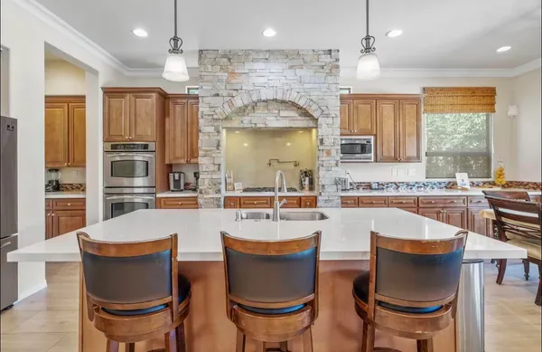 a large kitchen with a table and chairs