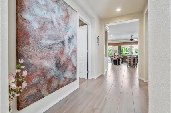 a hallway with a couch and a table with wooden floor