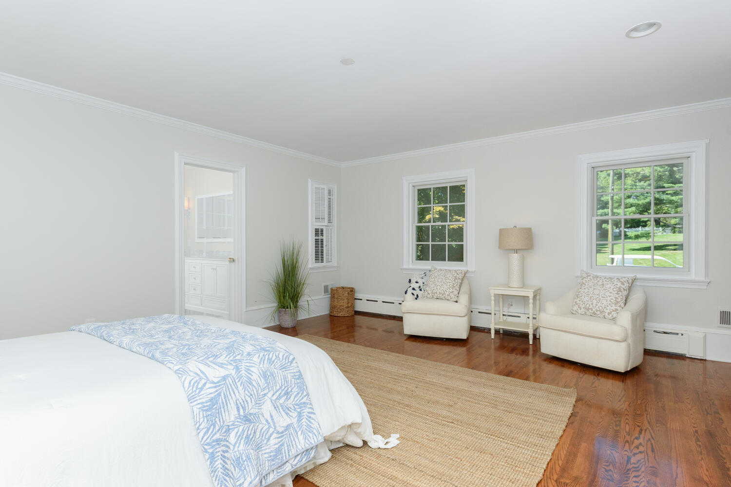9 Old Parish Road Darien, CT 06820 - Photo 30 of 49 a spacious bedroom with a bed a couch and wooden floor