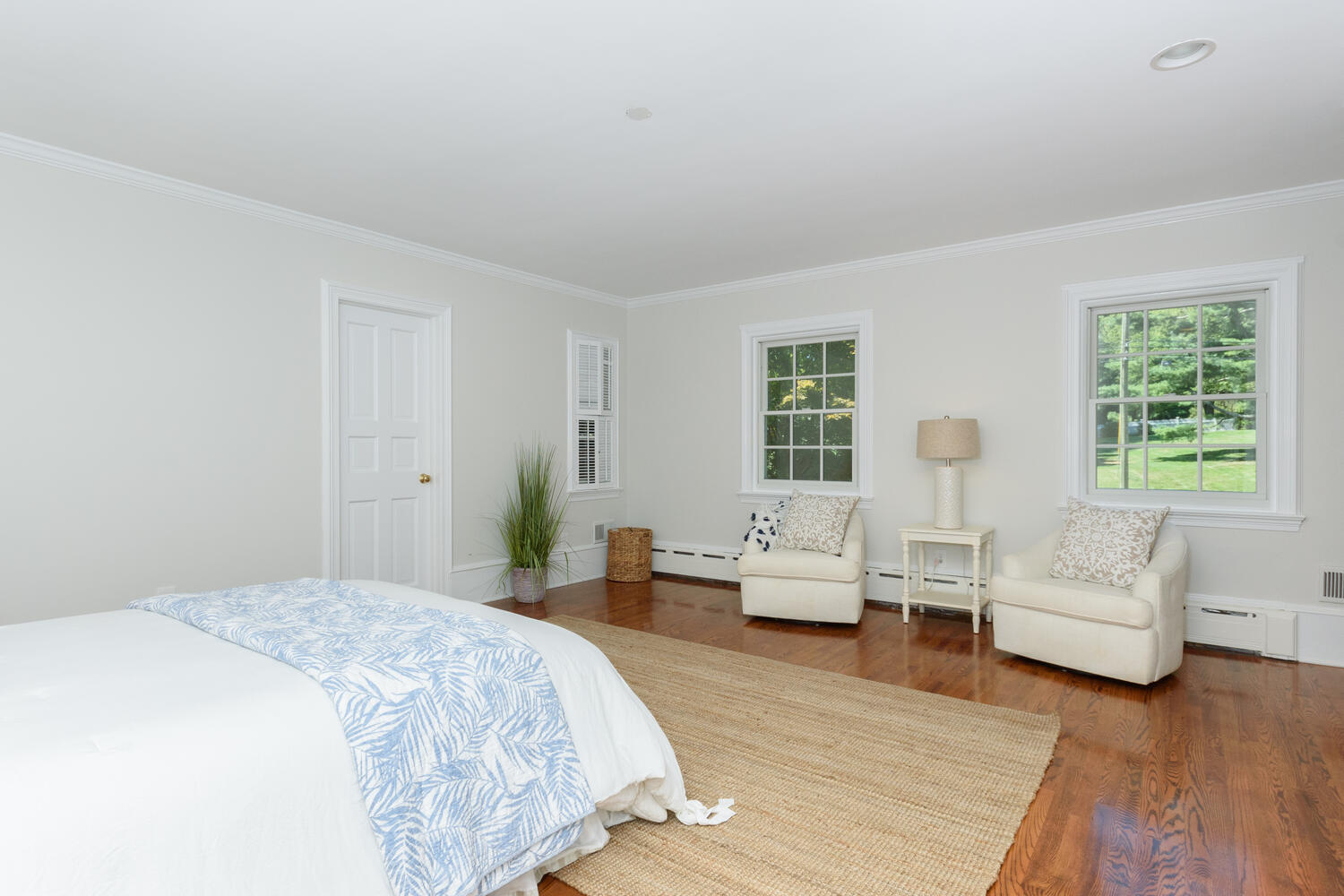 9 Old Parish Road Darien, CT 06820 - Photo 31 of 49 a spacious bedroom with a bed a couch and wooden floor