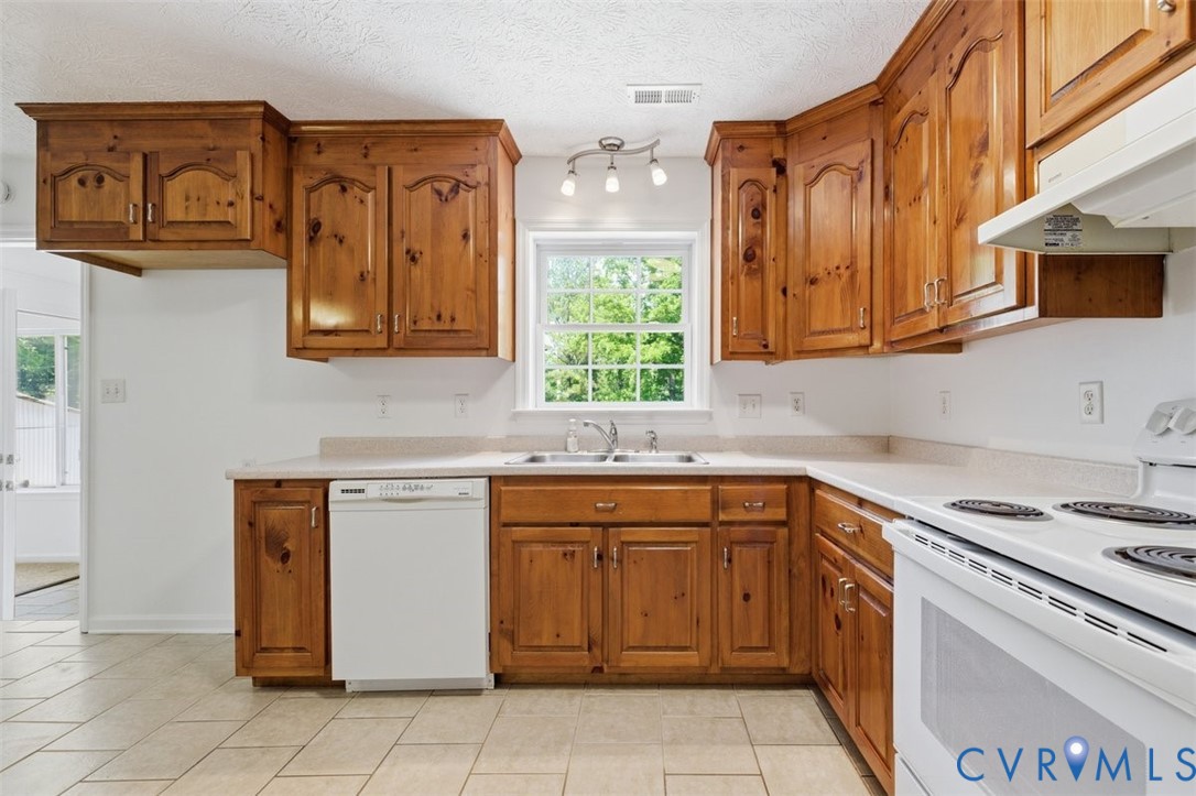 18501 Branders Bridge Road Colonial Heights, VA 23834 - Photo 13 of 43 a kitchen with stainless steel appliances granite countertop a sink and cabinets