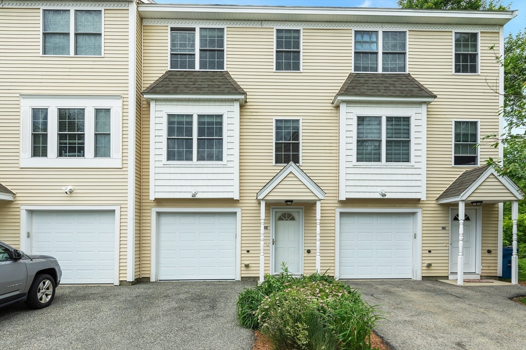 41 Boston Road, Unit 152 North Billerica, MA 01862 - Photo 1 of 1 a front view of a house with a yard