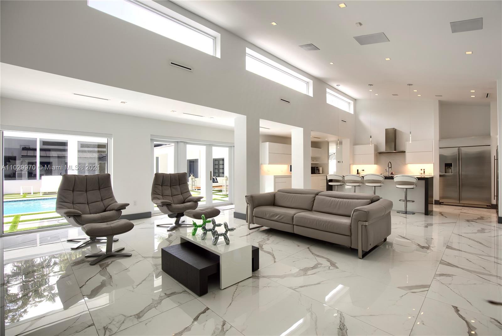 6460 Southwest 133rd Drive Pinecrest, FL 33156 - Photo 14 of 52 a living room with furniture kitchen view and a large window