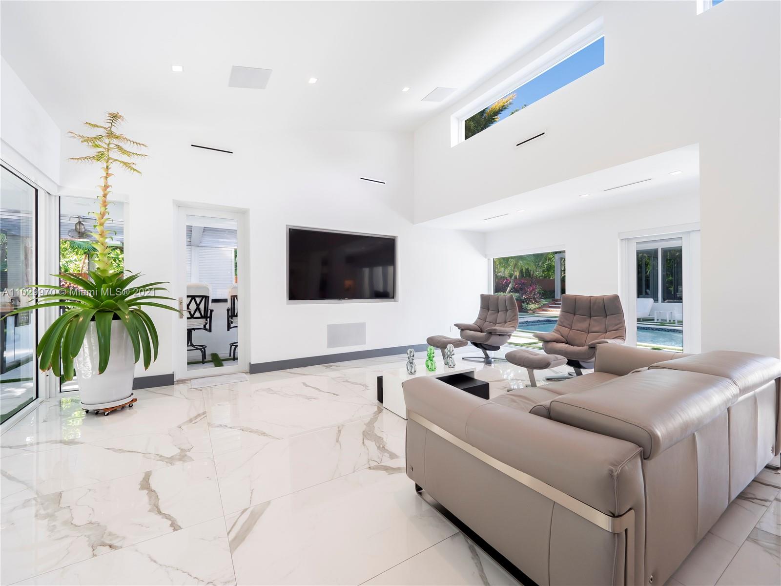 6460 Southwest 133rd Drive Pinecrest, FL 33156 - Photo 15 of 52 a living room with furniture potted plant and a flat screen tv