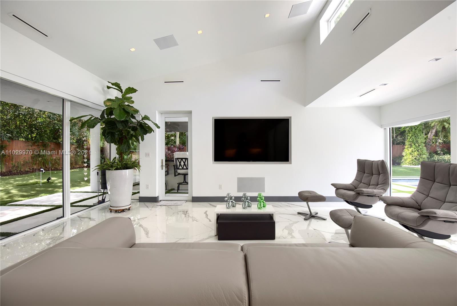 6460 Southwest 133rd Drive Pinecrest, FL 33156 - Photo 17 of 52 a living room with fireplace furniture and a flat screen tv