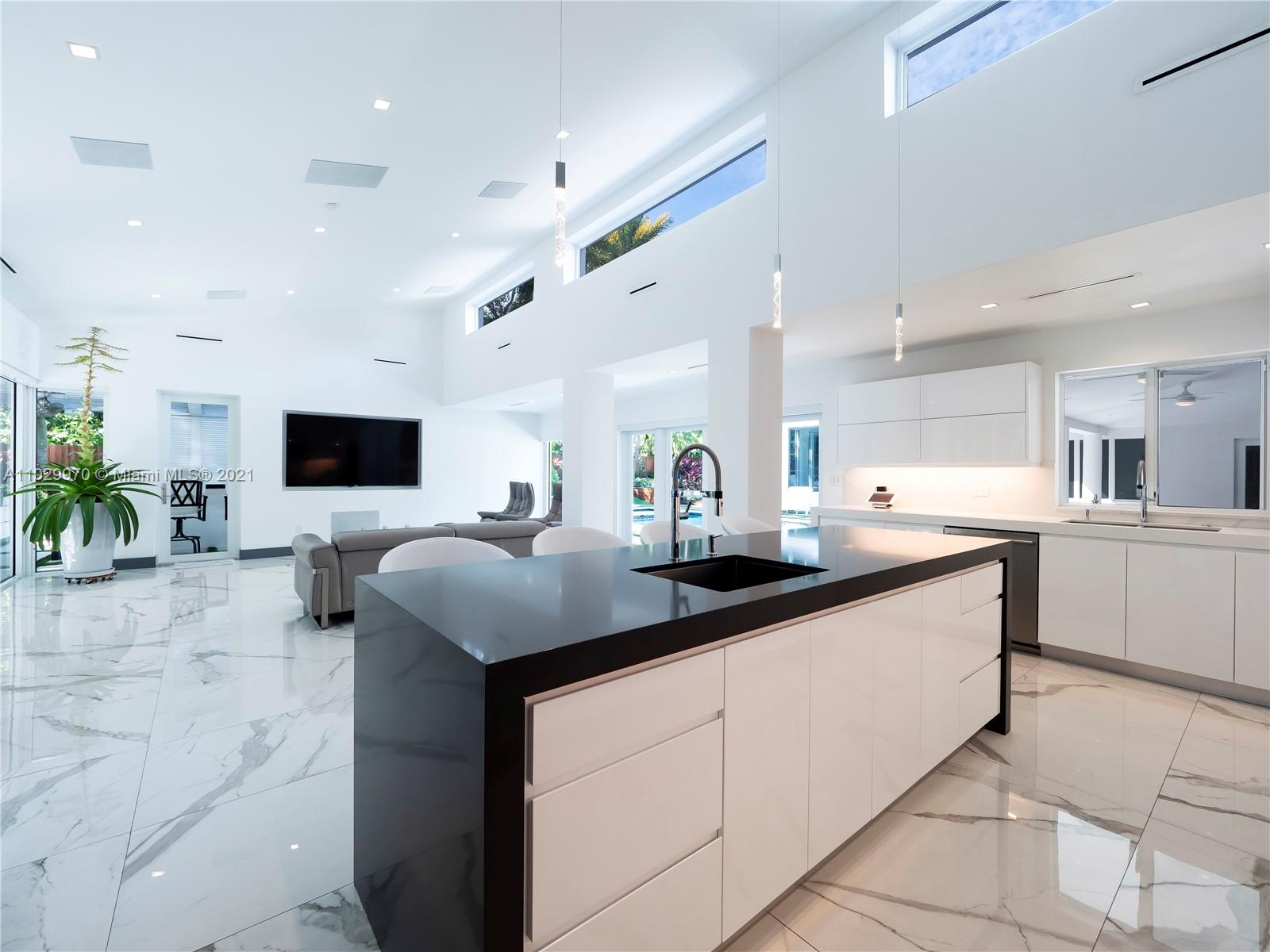 6460 Southwest 133rd Drive Pinecrest, FL 33156 - Photo 18 of 52 a kitchen with stainless steel appliances a sink and a stove top oven