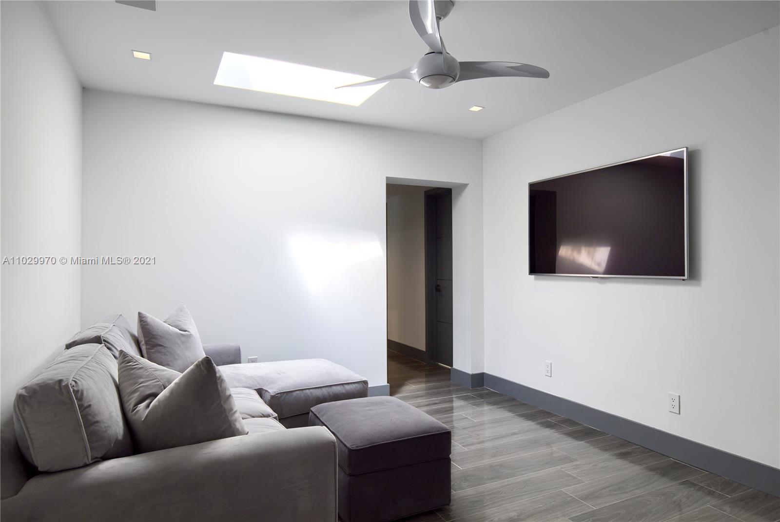 6460 Southwest 133rd Drive Pinecrest, FL 33156 - Photo 26 of 52 a living room with furniture and a flat screen tv
