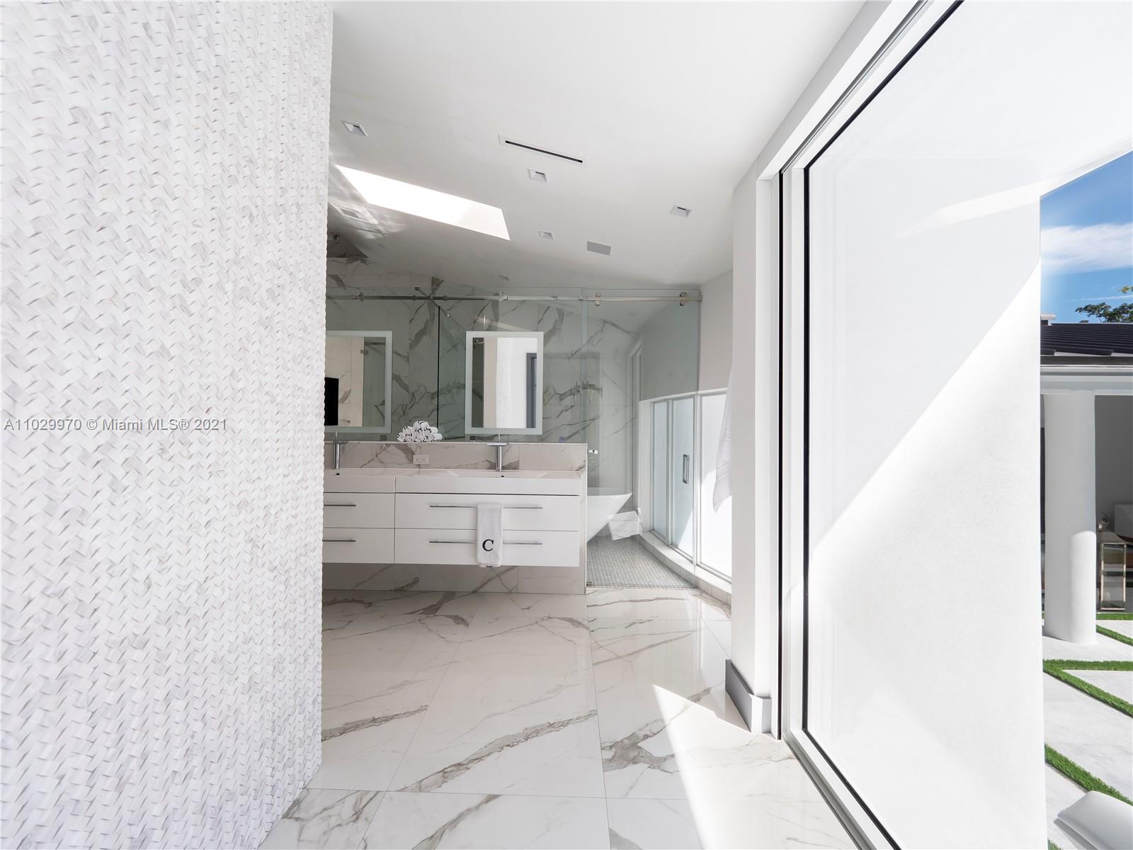 6460 Southwest 133rd Drive Pinecrest, FL 33156 - Photo 29 of 52 a bathroom with a sink a mirror and a toilet