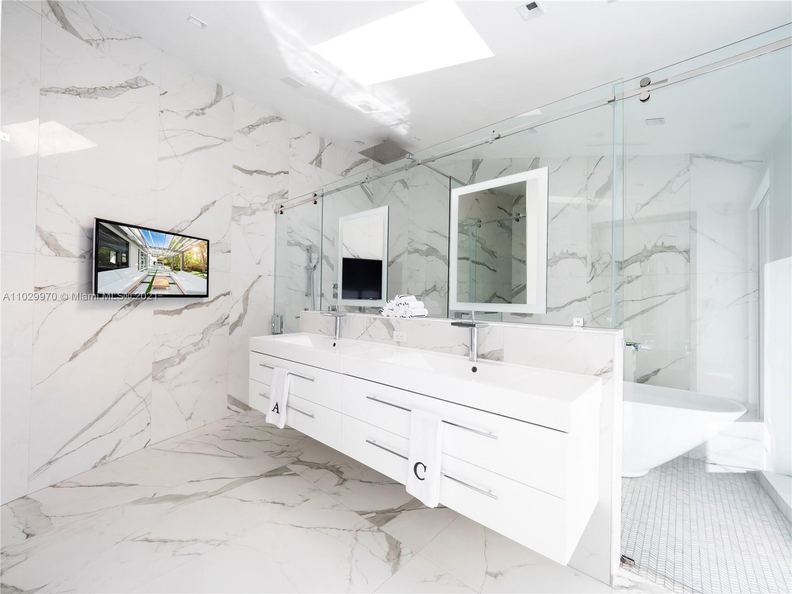 6460 Southwest 133rd Drive Pinecrest, FL 33156 - Photo 30 of 52 a bathroom with a sink mirror and vanity