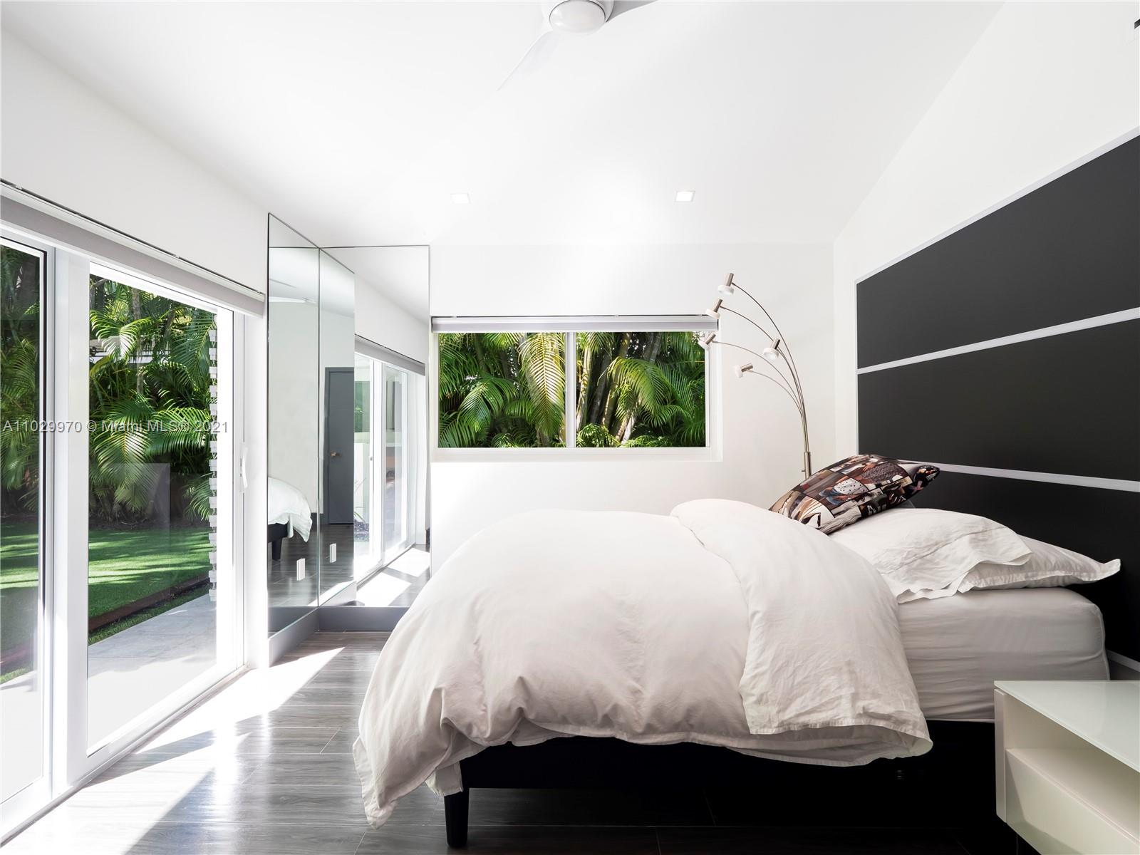 6460 Southwest 133rd Drive Pinecrest, FL 33156 - Photo 34 of 52 a bedroom with a bed and a large window