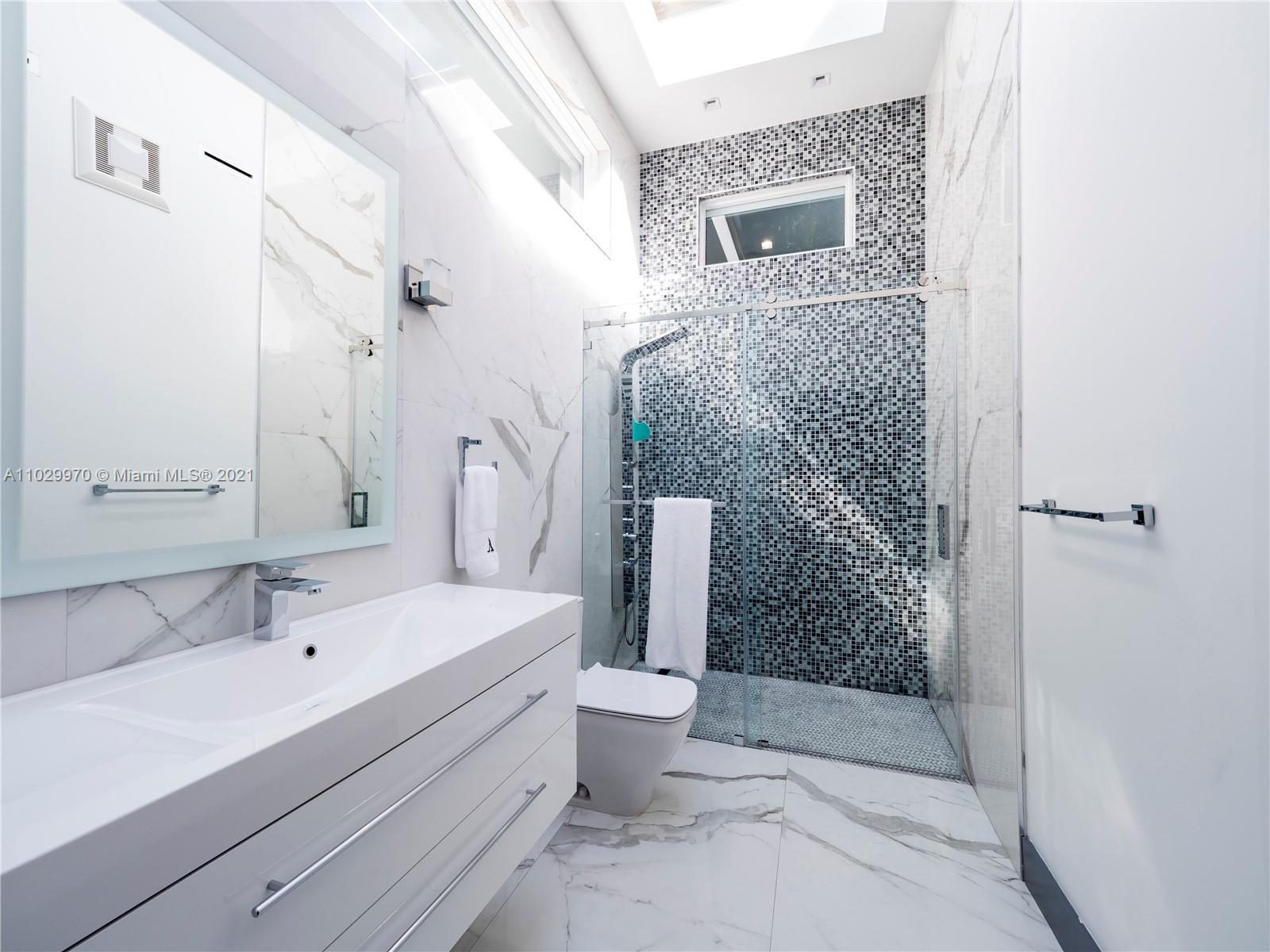 6460 Southwest 133rd Drive Pinecrest, FL 33156 - Photo 35 of 52 a bathroom with a sink a toilet and shower