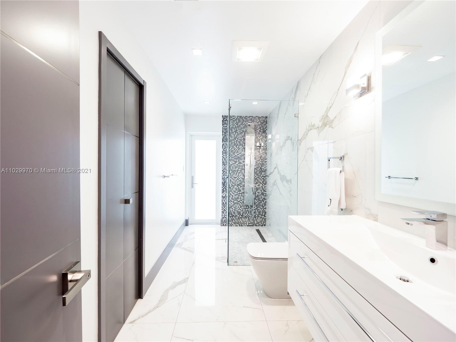 6460 Southwest 133rd Drive Pinecrest, FL 33156 - Photo 36 of 52 a bathroom with a double vanity sink toilet and shower