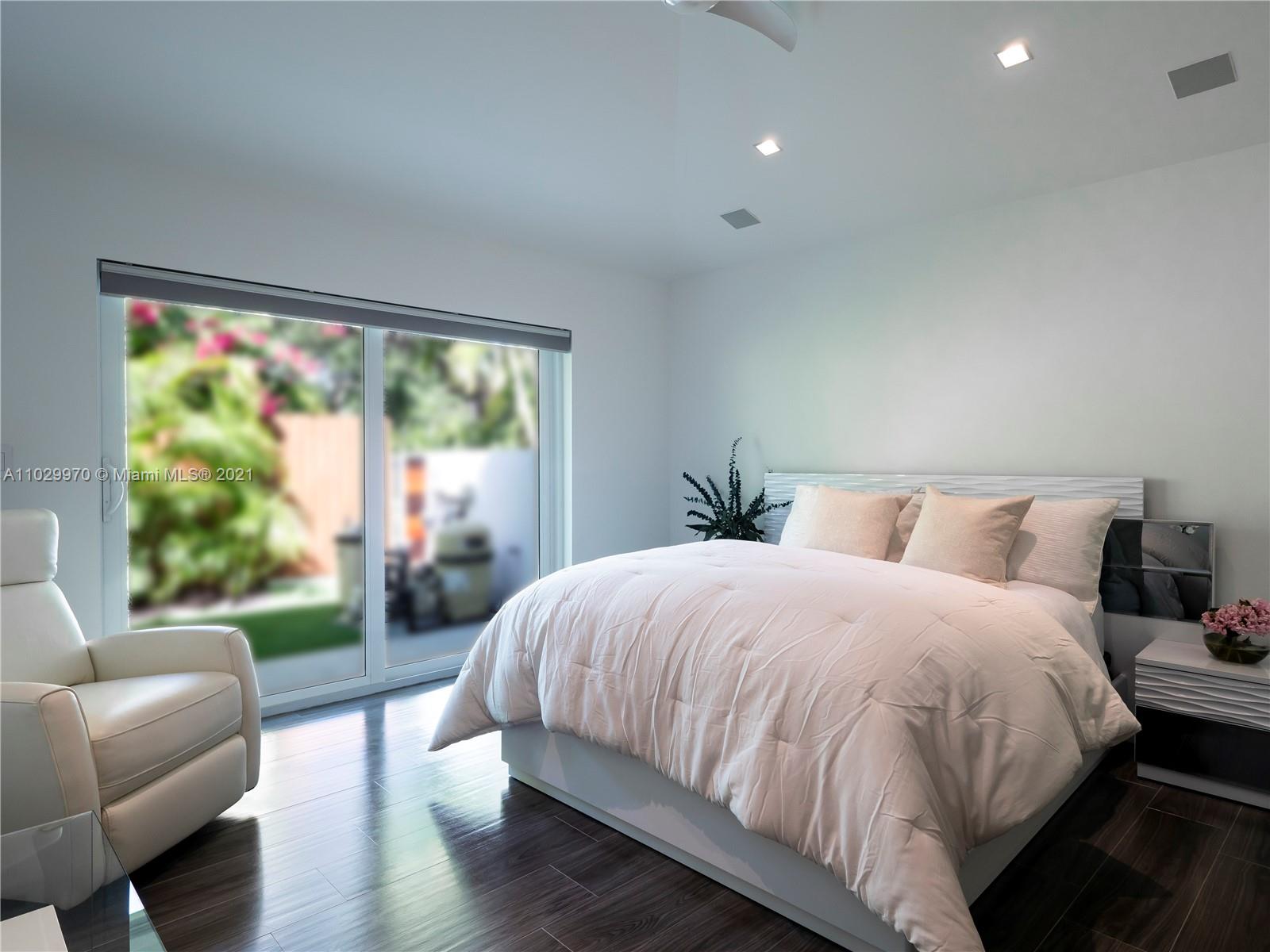 6460 Southwest 133rd Drive Pinecrest, FL 33156 - Photo 37 of 52 a bedroom with a bed and a large window