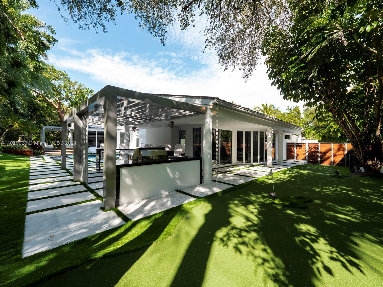6460 Southwest 133rd Drive Pinecrest, FL 33156 - Photo 40 of 52 a view of a house with a yard