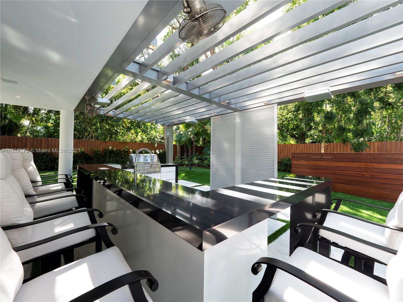 6460 Southwest 133rd Drive Pinecrest, FL 33156 - Photo 41 of 52 a view of a patio with a table chairs and a backyard