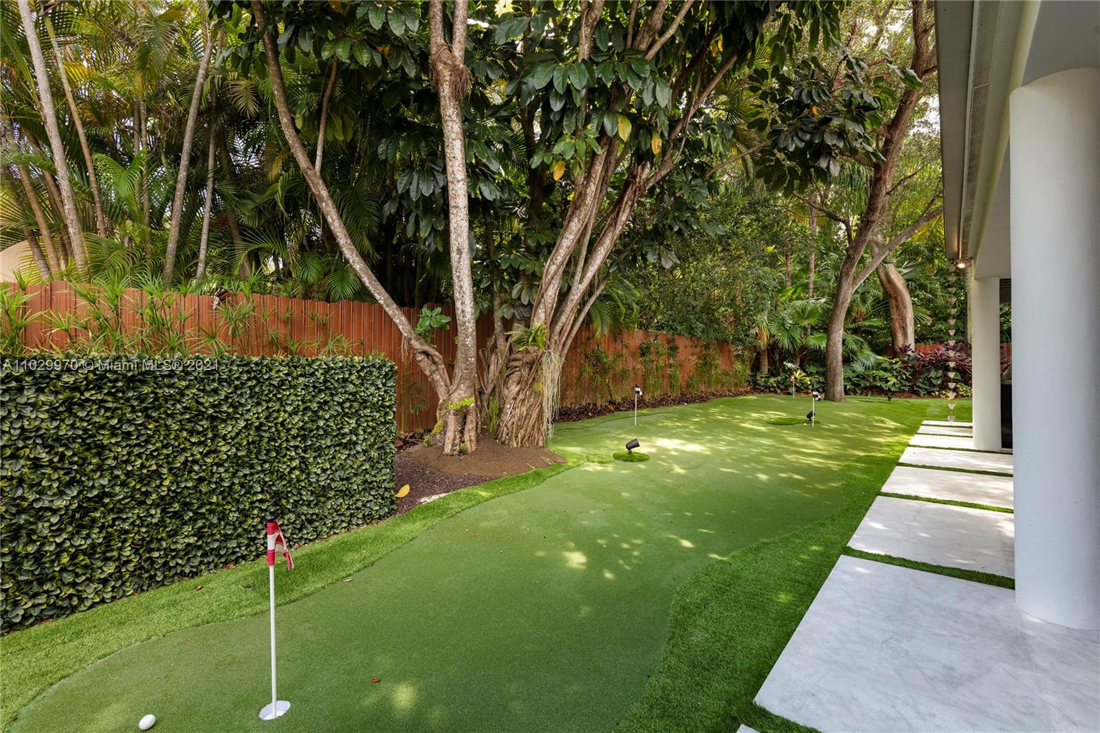 6460 Southwest 133rd Drive Pinecrest, FL 33156 - Photo 42 of 52 a backyard of a house with lots of green space