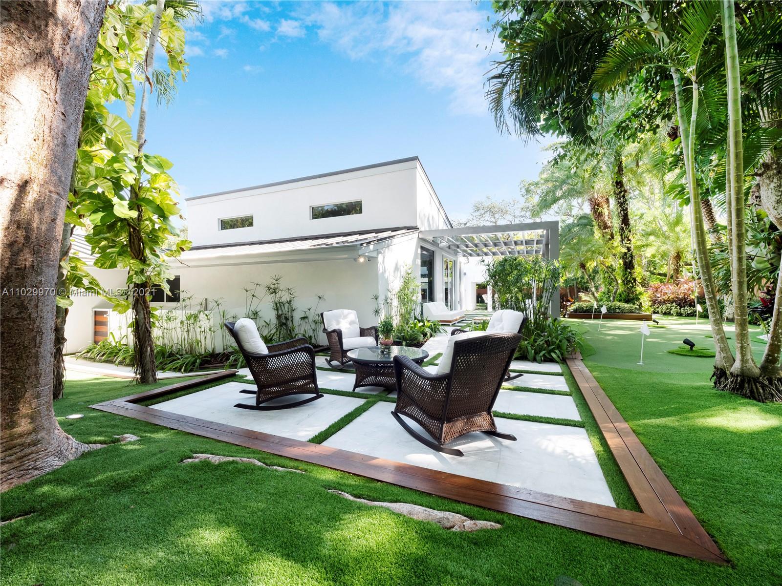 6460 Southwest 133rd Drive Pinecrest, FL 33156 - Photo 47 of 52 a front view of a house with garden and sitting area
