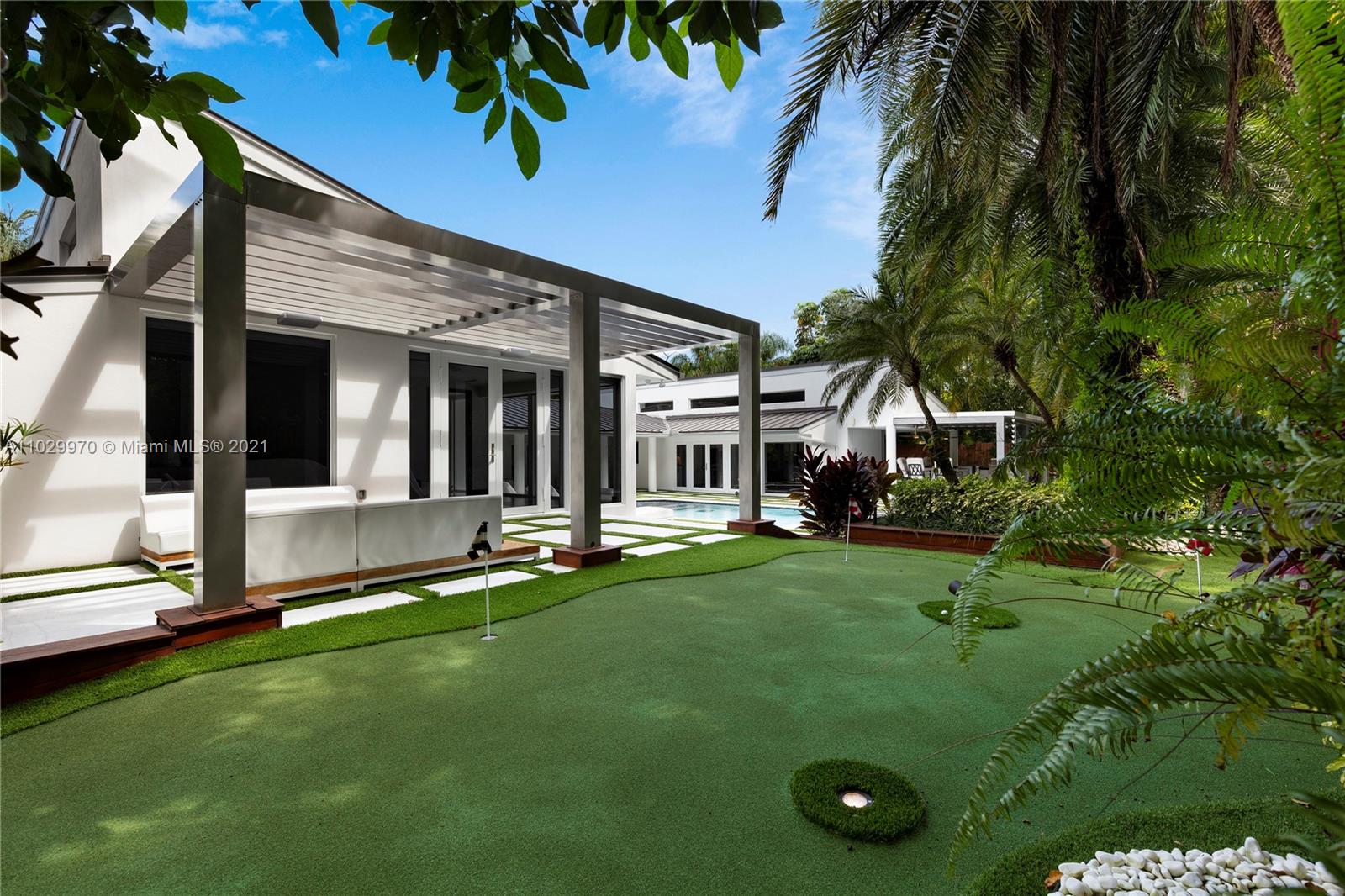 6460 Southwest 133rd Drive Pinecrest, FL 33156 - Photo 49 of 52 a view of a house with backyard and sitting area