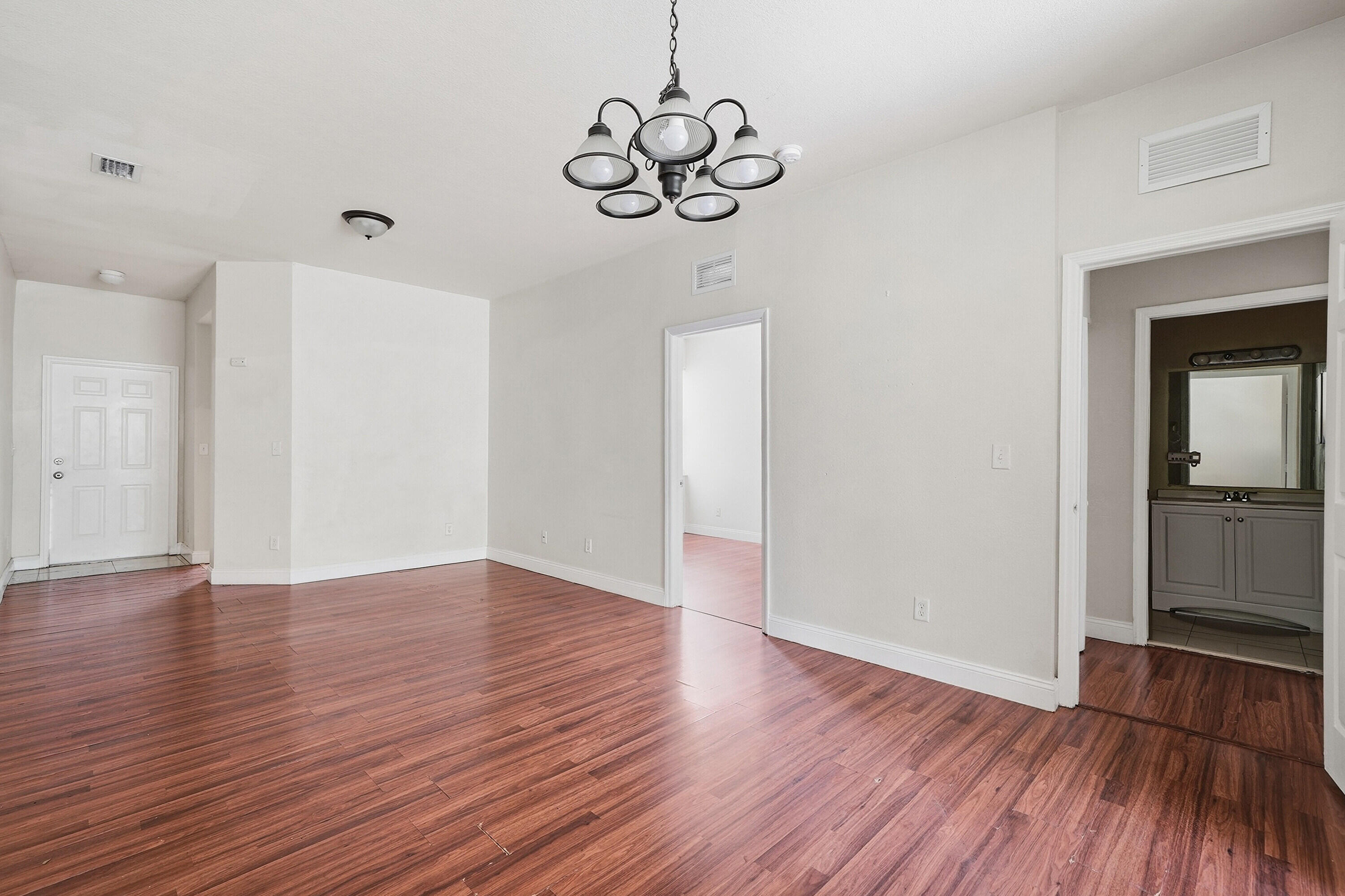 1584 Southwest 2nd Street Homestead, FL 33030 - Photo 12 of 28 a view of an empty room with wooden floor and a window