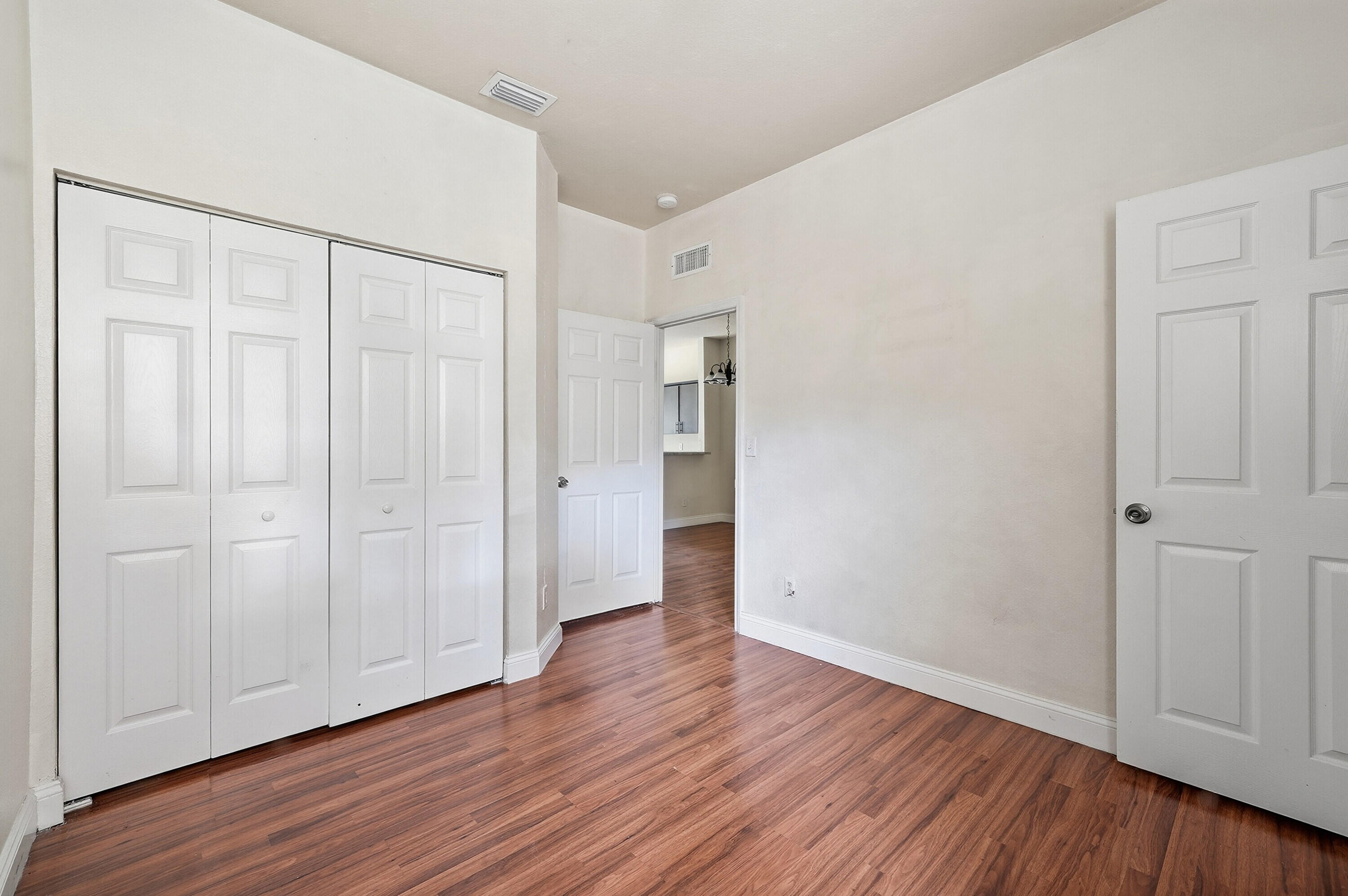 1584 Southwest 2nd Street Homestead, FL 33030 - Photo 16 of 28 a view of an empty room with wooden floor