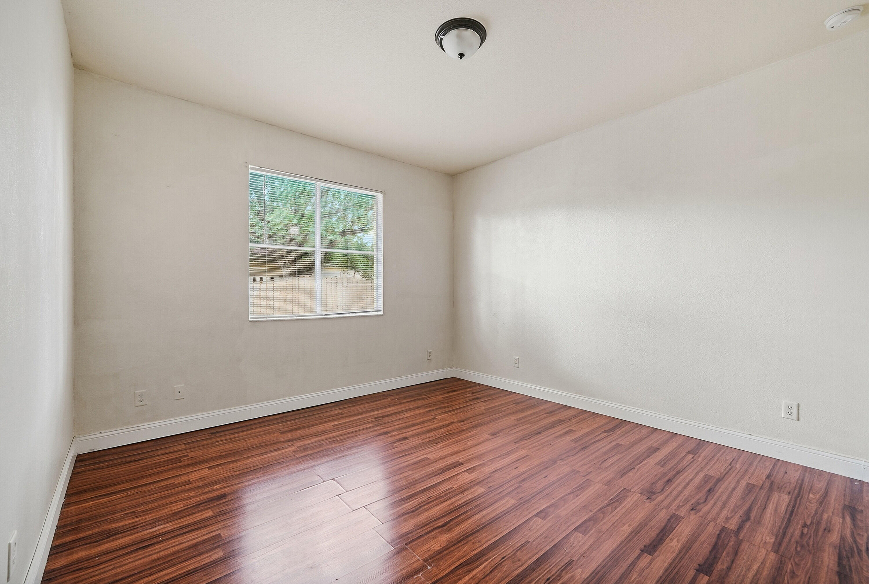 1584 Southwest 2nd Street Homestead, FL 33030 - Photo 18 of 28 an empty room with wooden floor and windows
