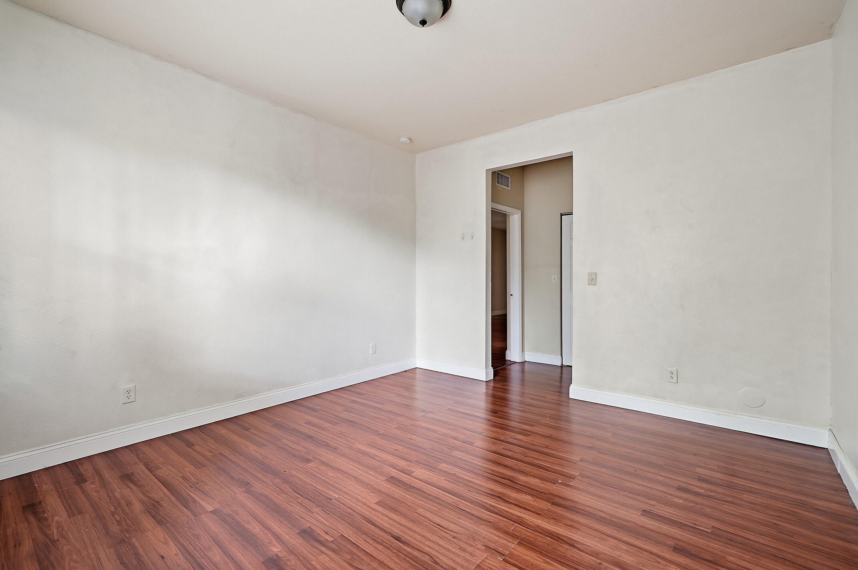 1584 Southwest 2nd Street Homestead, FL 33030 - Photo 19 of 28 a view of an empty room with wooden floor and windows