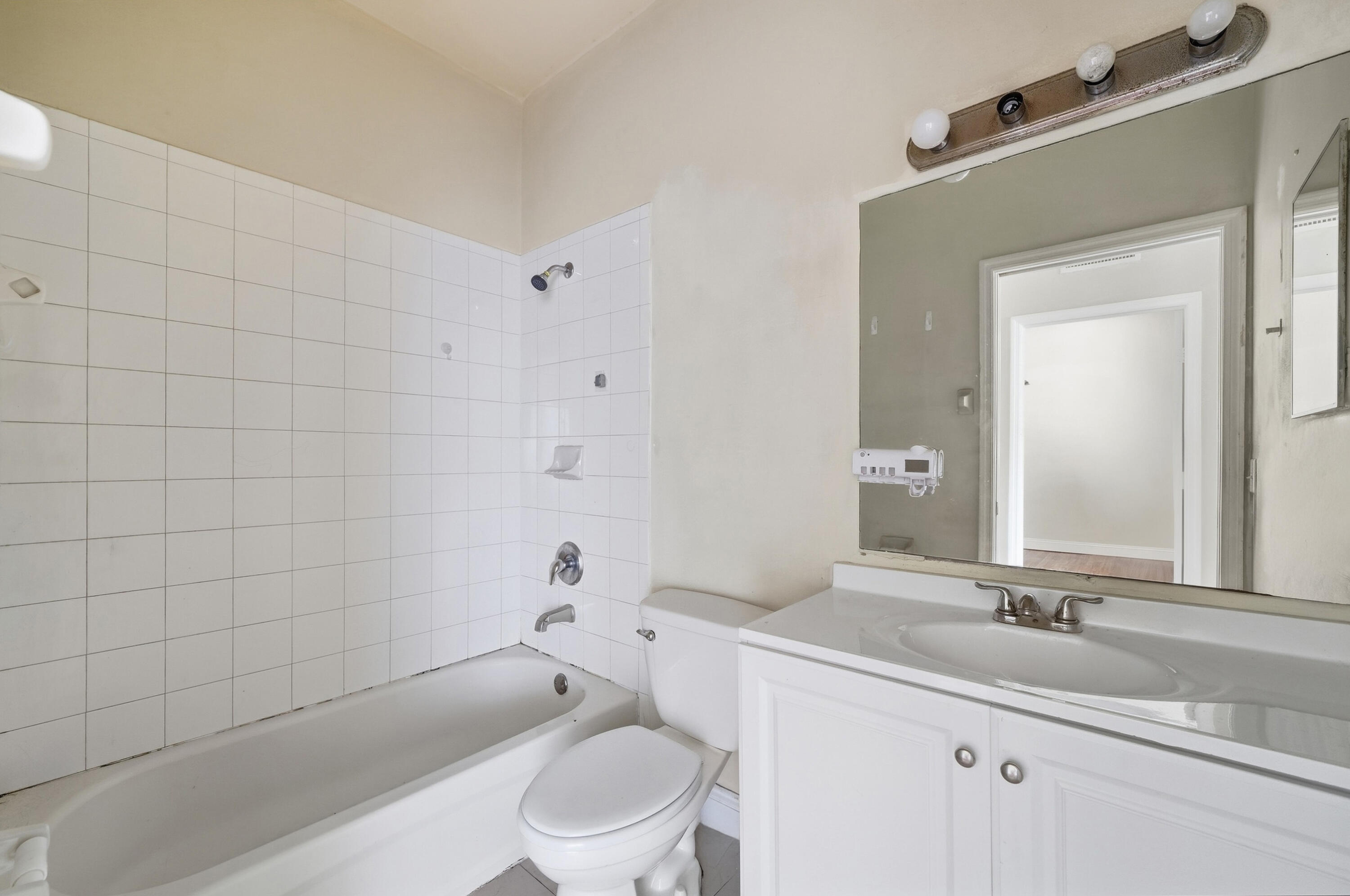 1584 Southwest 2nd Street Homestead, FL 33030 - Photo 20 of 28 a bathroom with a bathtub shower sink mirror vanity and toilet