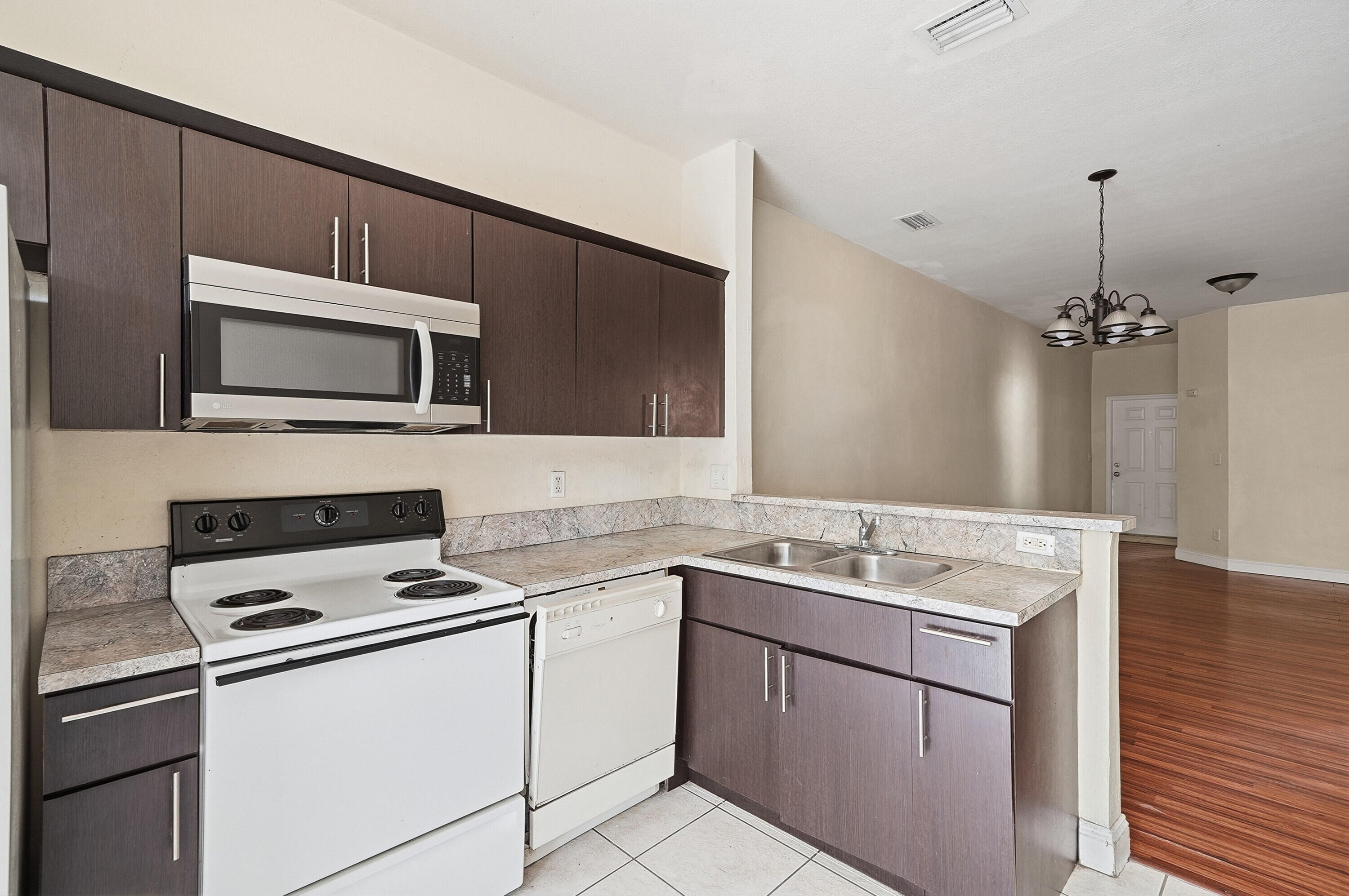 1584 Southwest 2nd Street Homestead, FL 33030 - Photo 3 of 28 a kitchen with a sink stove and microwave