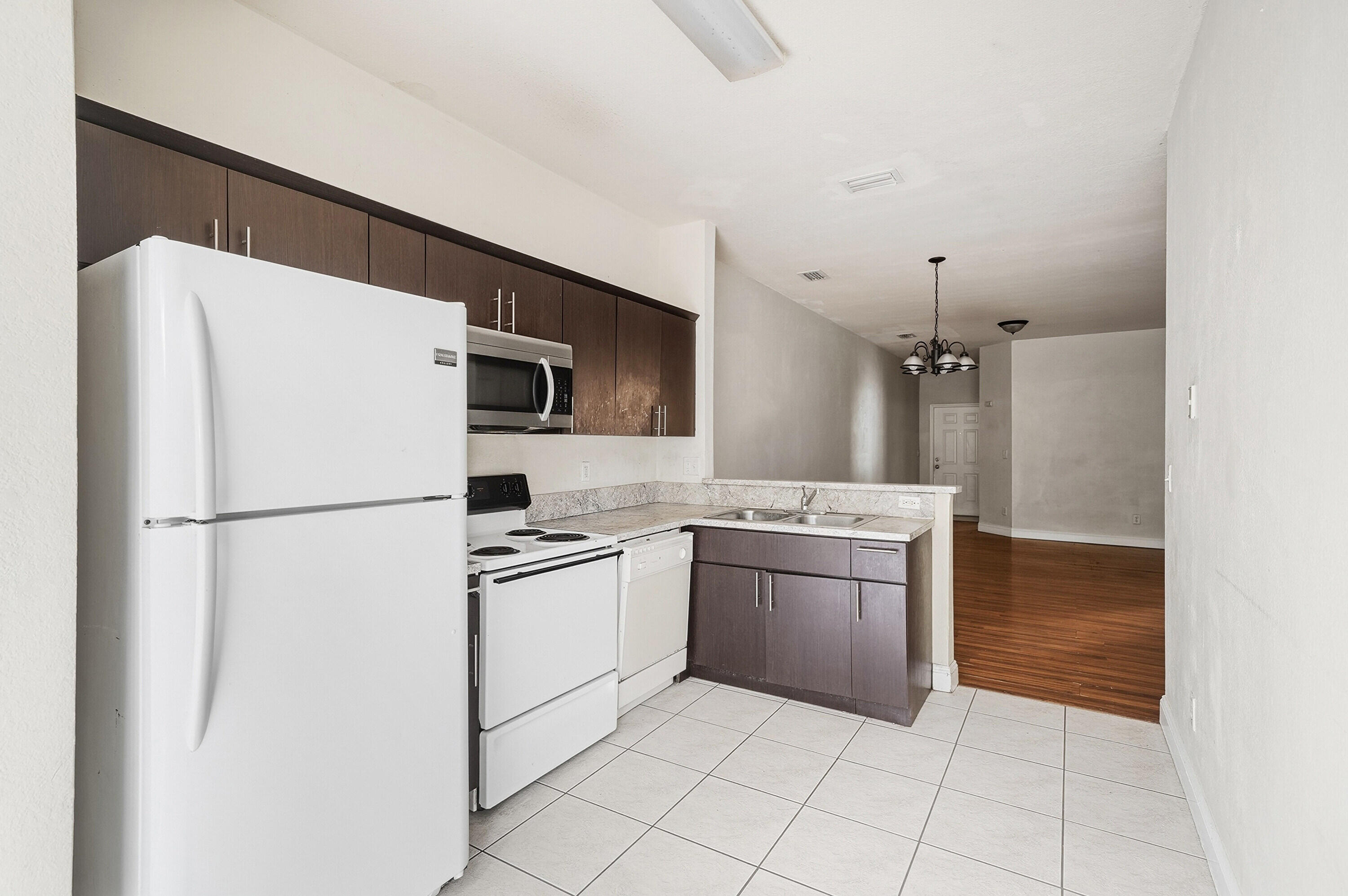1584 Southwest 2nd Street Homestead, FL 33030 - Photo 6 of 28 a kitchen with cabinets and stainless steel appliances