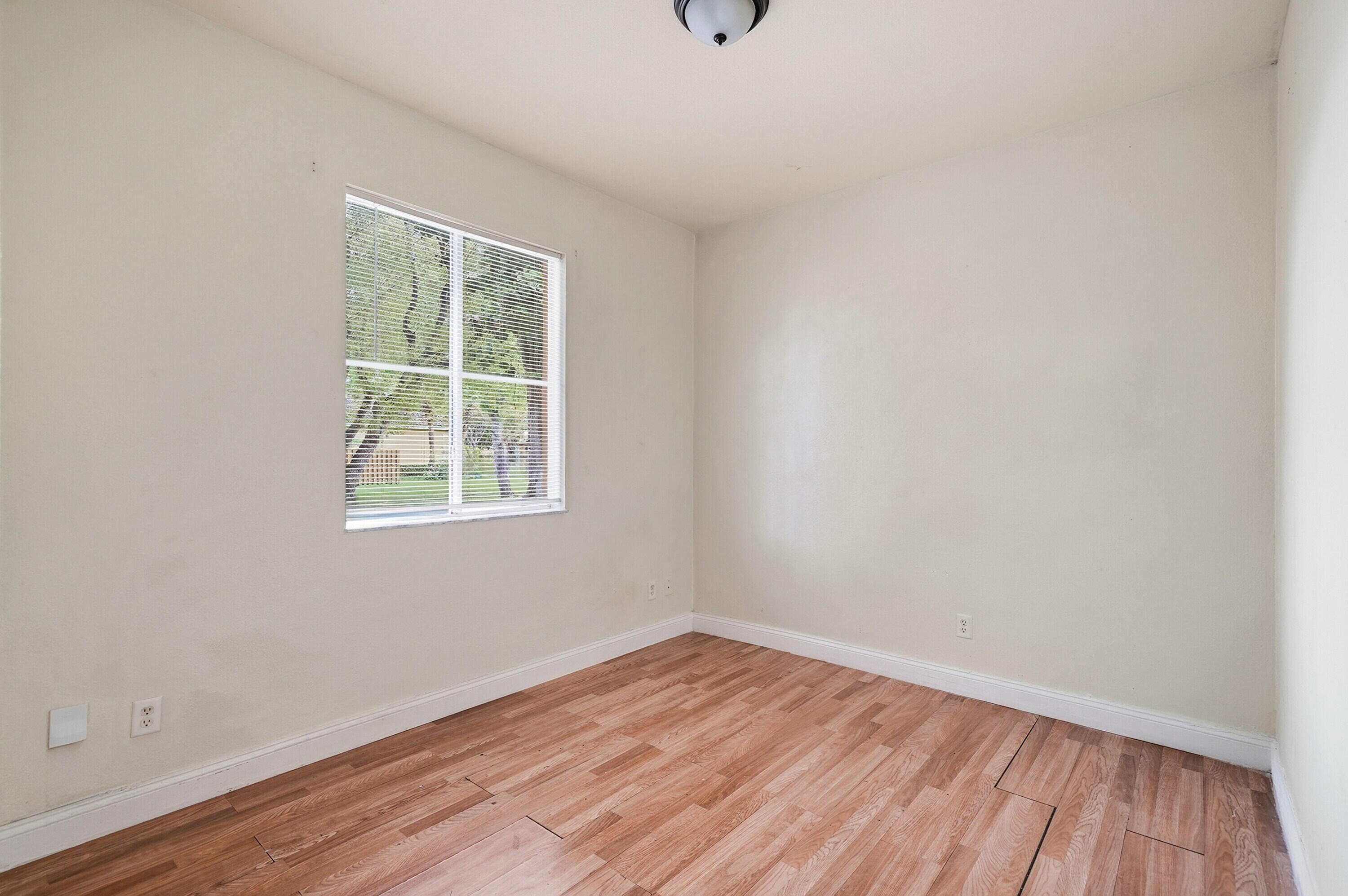 1584 Southwest 2nd Street Homestead, FL 33030 - Photo 9 of 28 an empty room with wooden floor and windows