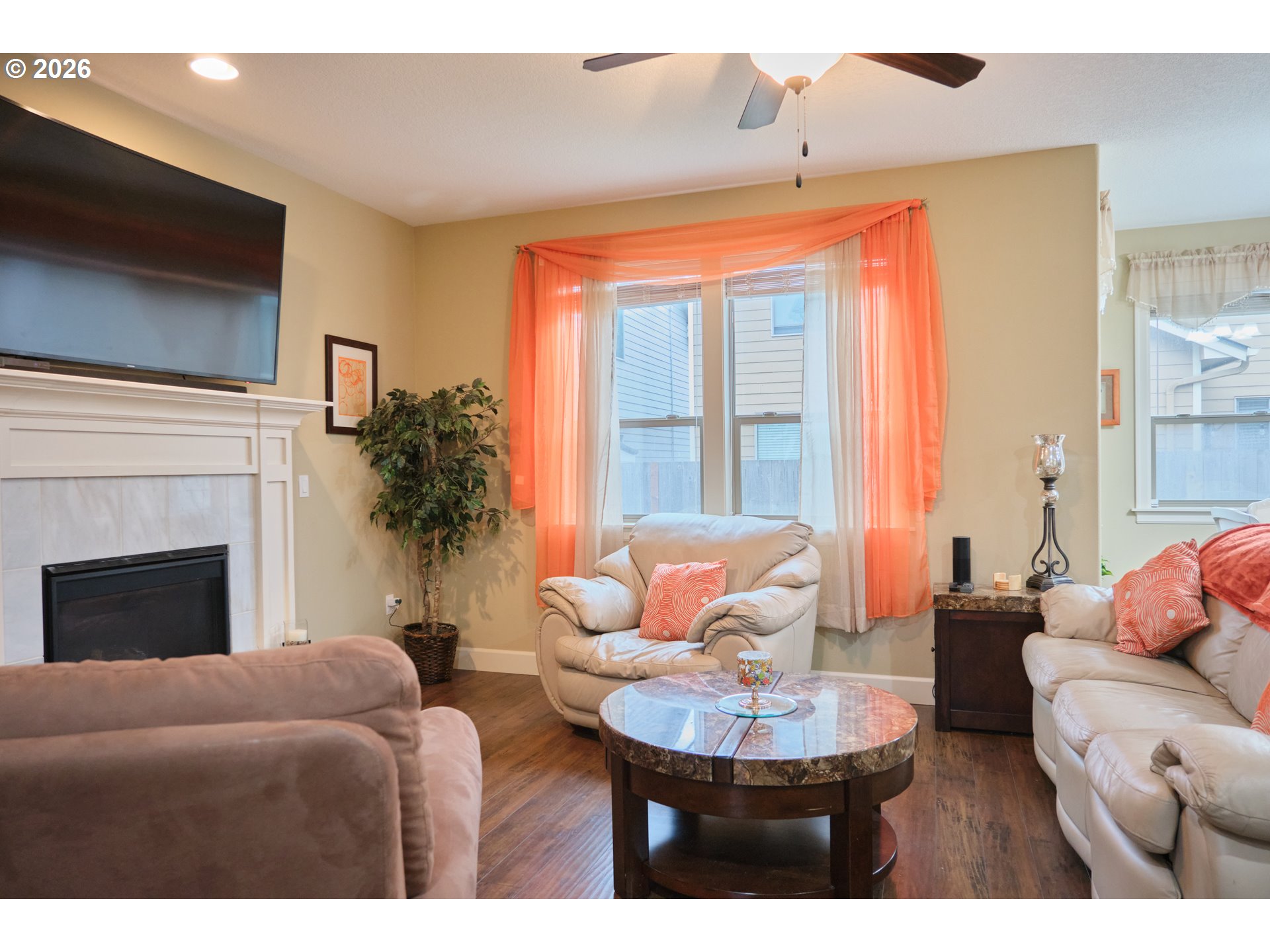 1168 Taurus Loop Northeast Keizer, OR 97303 - Photo 4 of 30 a living room with furniture a fireplace and a flat screen tv