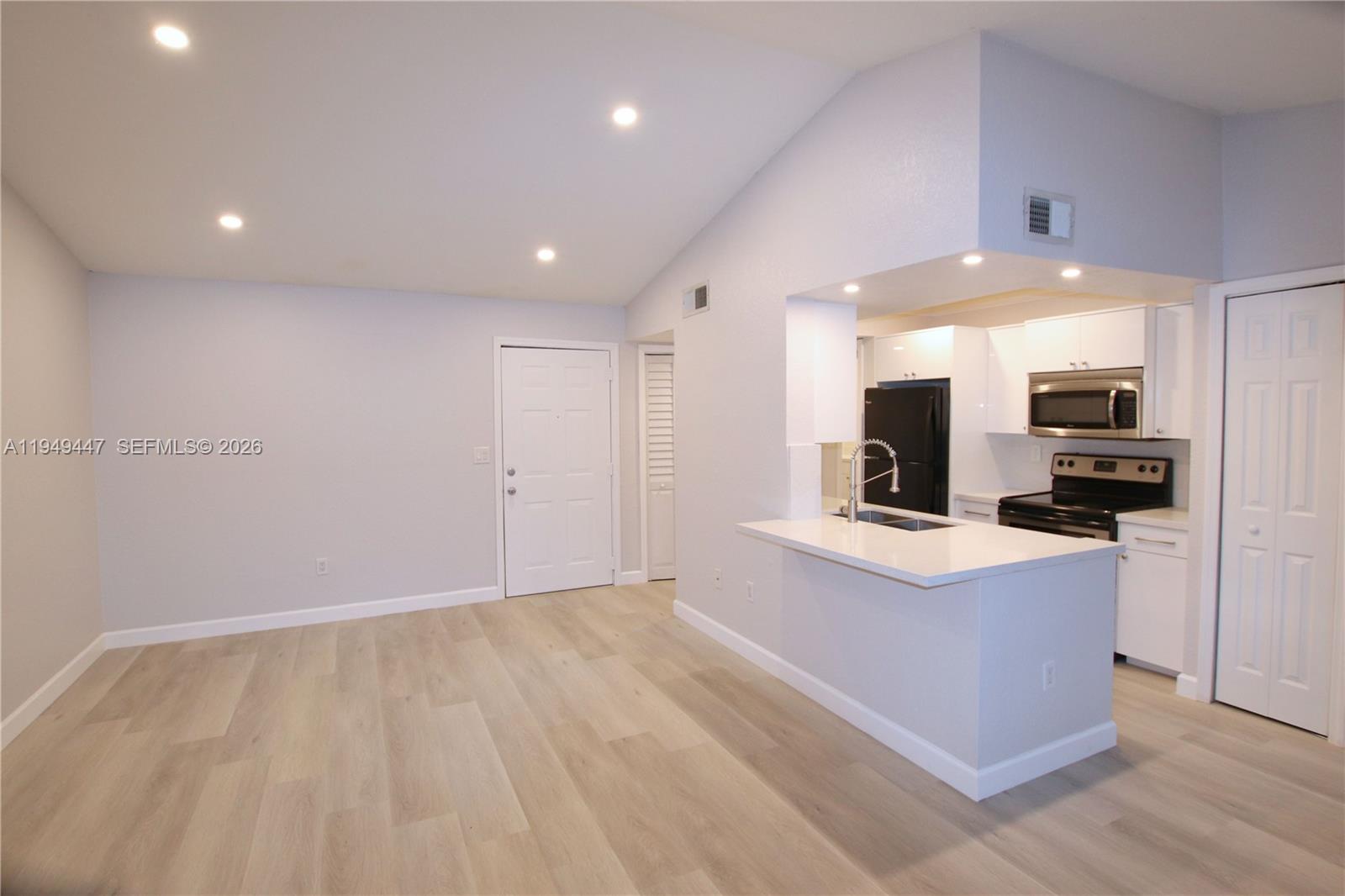 a view of kitchen with stainless steel appliances refrigerator stove microwave and refrigerator